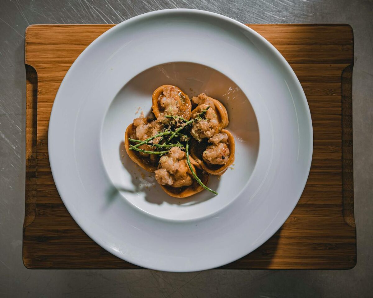Delicious gourmet dish elegantly served on a white plate with a wooden board.